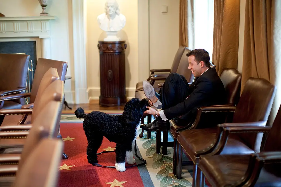A White House Deputy Director of Oval Office Operations Brian Mosteller attempts to protect his shoes as he plays with t
